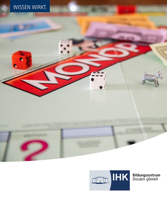 Close-up of a Monopoly game board featuring colorful dice, a metal dog token, and various denominations of play money. The text "WISSEN WIRKT" is displayed at the top, alongside a logo for IHK Bildungszentrum Dresden gGmbH in the bottom corner.