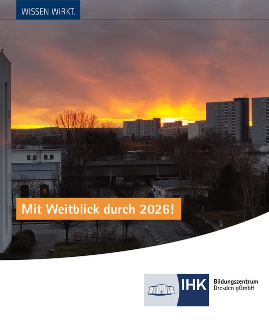 A vibrant sunset fills the sky with warm oranges and yellows. The foreground features a cityscape with buildings and trees, conveying a sense of community. Text overlay states: "Mit Weitblick durch 2026!" and includes a logo for IHK Bildungszentrum Dresden gGmbH.