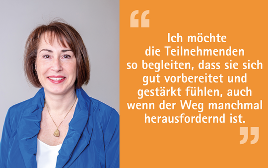 Ein Porträt einer lächelnden Frau mit kurzen, braunen Haaren, die eine blaue Jacke trägt. Neben ihr steht ein Zitat, in dem sie erklärt, dass sie Teilnehmer unterstützen möchte, sich gut vorbereitet und gestärkt zu fühlen, auch wenn der Weg herausfordernd ist.